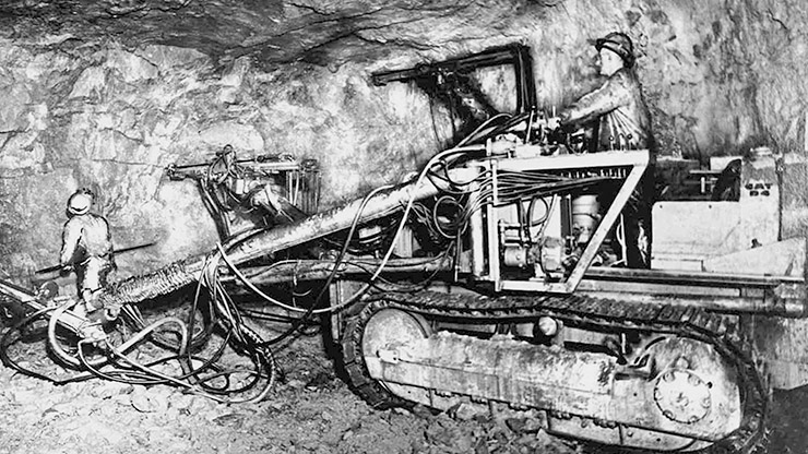 Historical photo of an employee operating an original jumbo drill designed by Doe Run predecessor company, circa 1960.